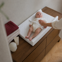 Bébé allongé sur le matelas à langer blanc NOLIERA | NOLIERA