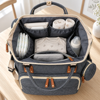 Sac à dos à langer gris NOLIERA ouvert et organisé avec les essentiels de bébé