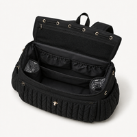 Intérieur du sac à dos à langer tressé noir ouvert, rangements | NOLIERA